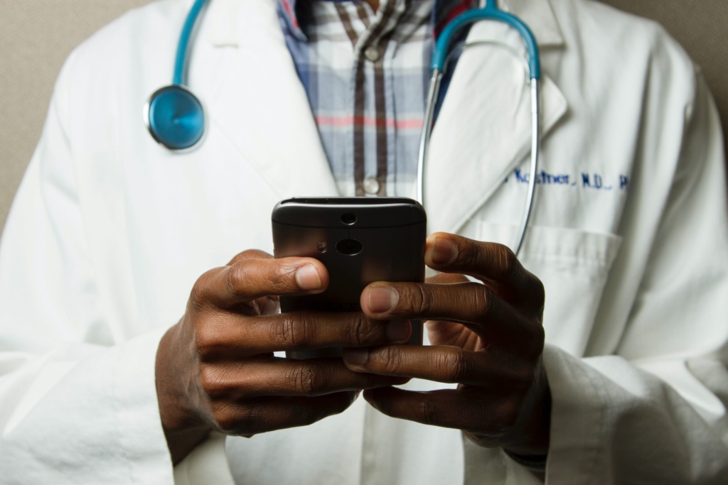 Healthcare professional looking at his mobile phone.
