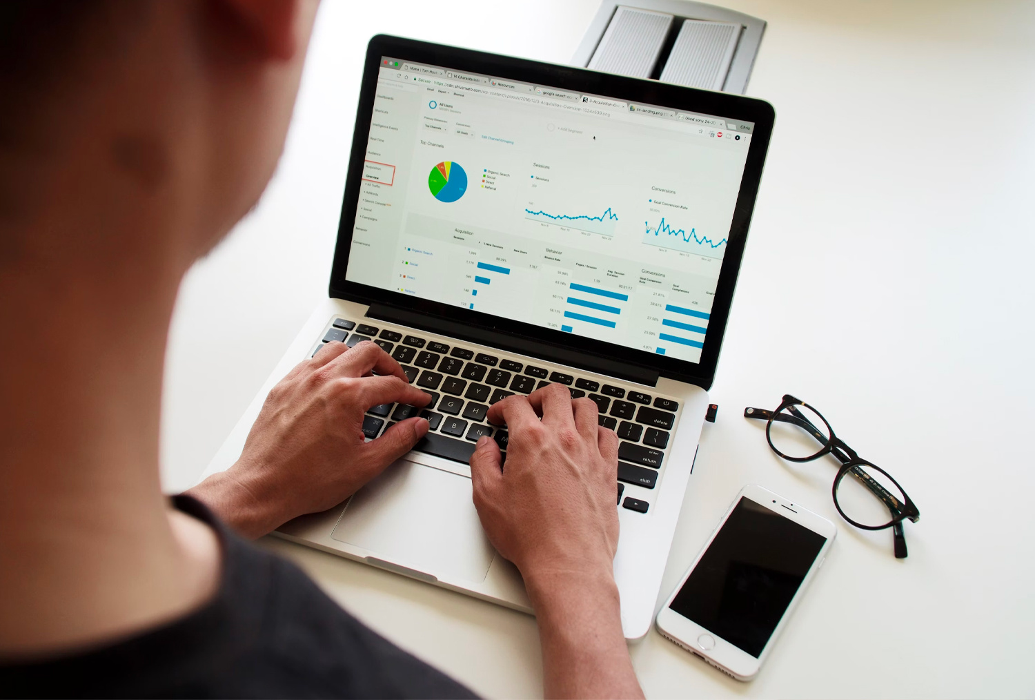 Someone looking at a analytics report on their computer