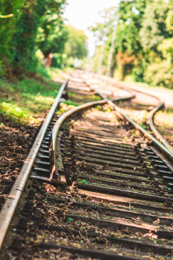 Choosing the right path for engagement Railroad tracks splitting into two directions, representing different paths for audience engagement strategies.