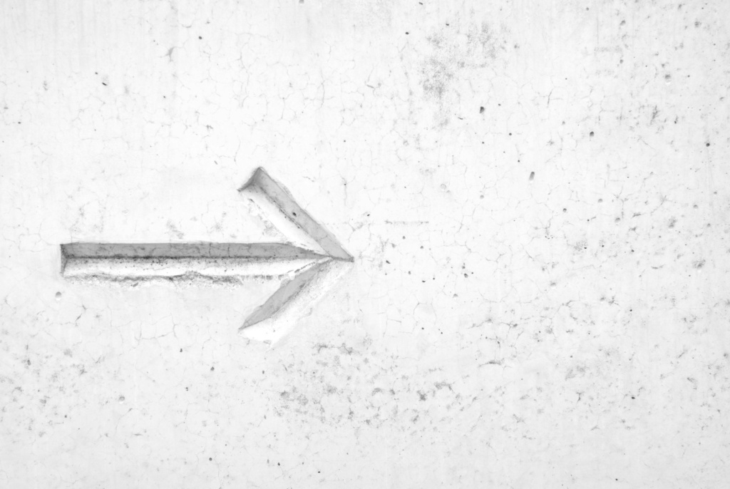 Clear direction in marketing strategy White arrow pointing forward, symbolizing clear direction in marketing strategy.