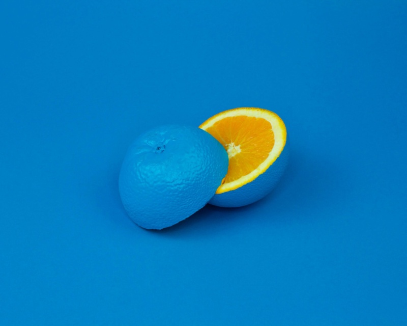 Cut open orange that it painted blue on the outside
