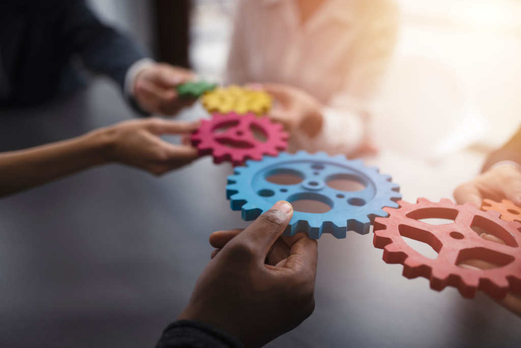Colorful gears Hands holding colorful gears symbolizing teamwork and integration.