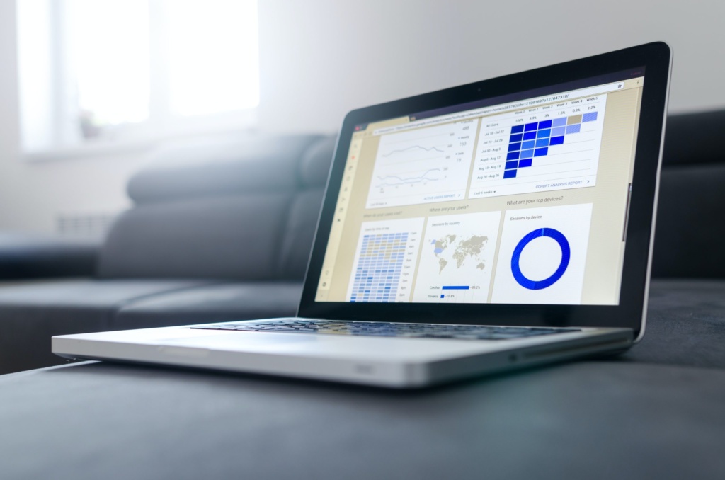 Digital analytics dashboard on laptop screen Open laptop displaying analytics dashboards with charts and graphs.