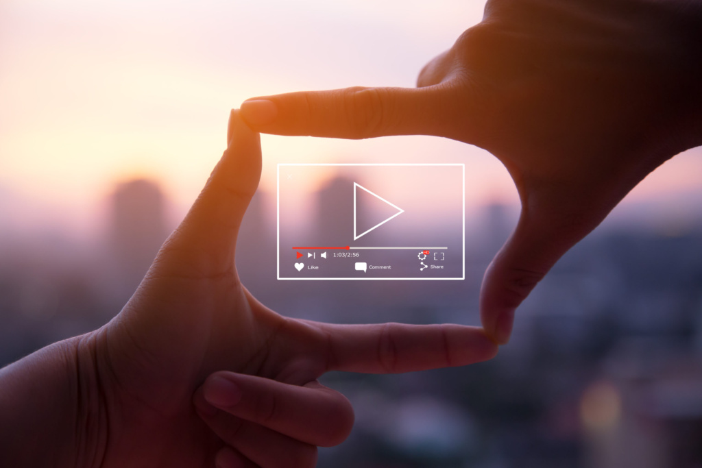 Hands framing video storytelling concept with play icon overlay Hands framing a rectangle like a camera viewfinder with a digital video play icon overlay, symbolizing video creation and storytelling.