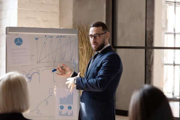 Man pointing at white board