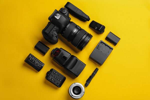 Pieces of a camera on a yellow backdrop
