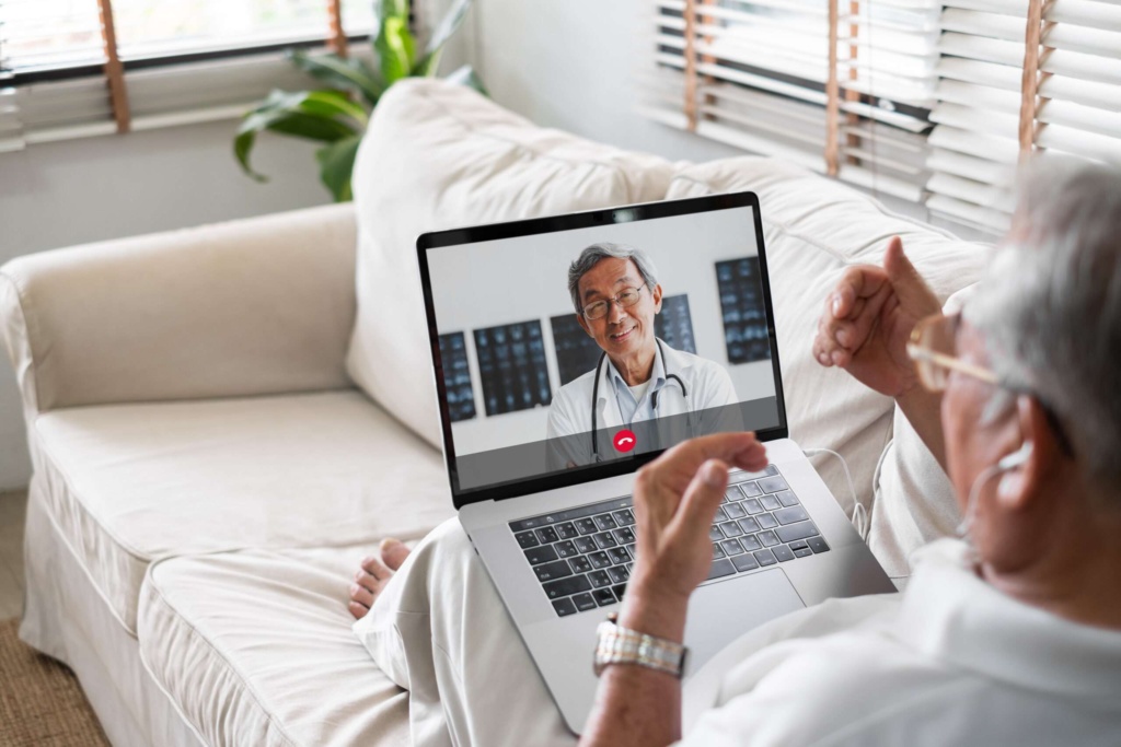 Telehealth consultation between doctor and patient Senior patient using a laptop for a telehealth video call with a doctor.