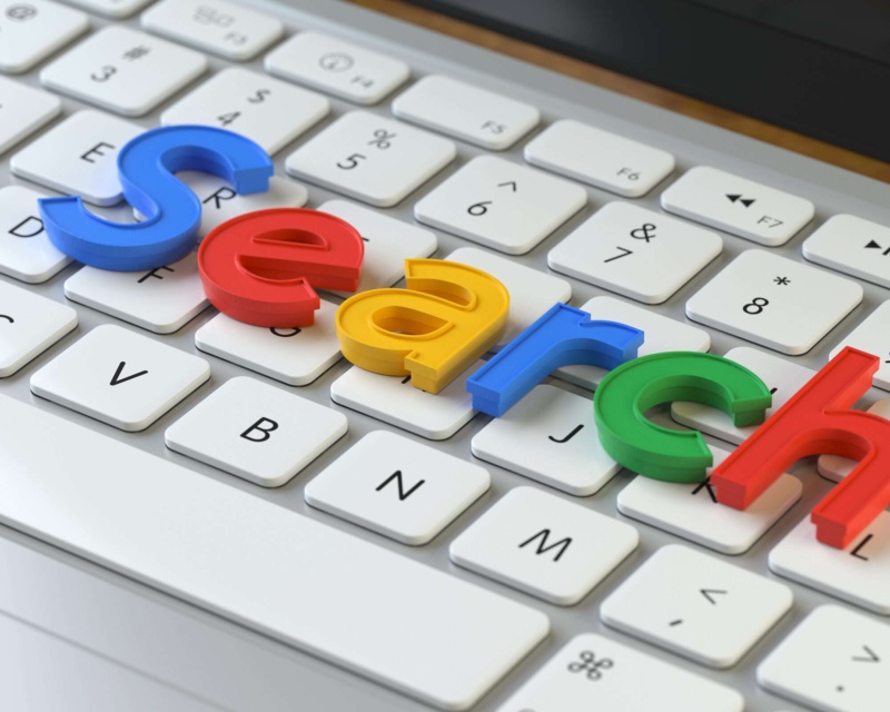A keyboard with the words "search" over it