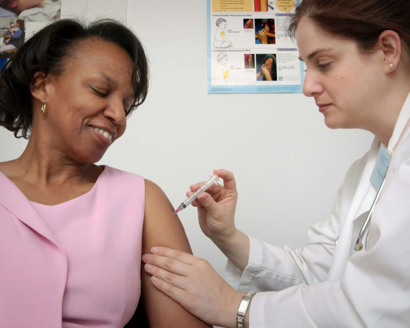 A doctor giving a patient a shot