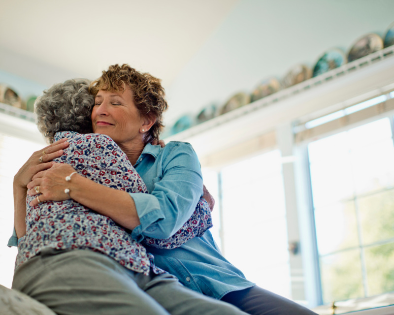 Two older women hugging