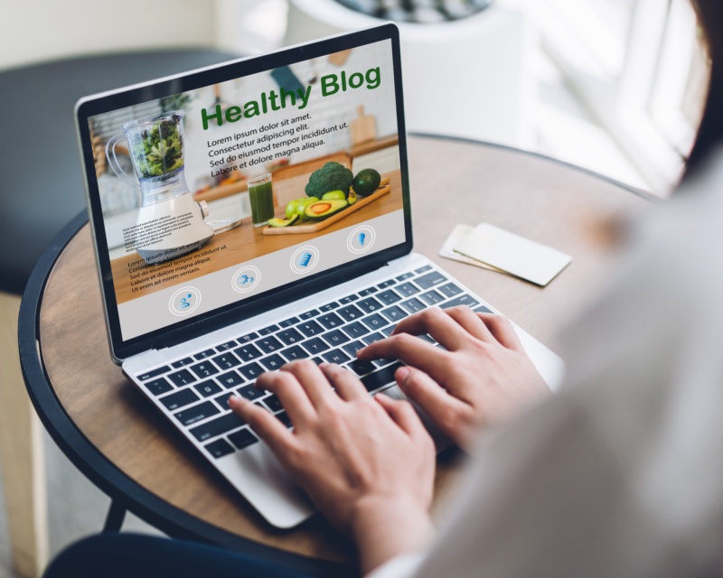 A woman looking at a healthcare marketing blog on her laptop