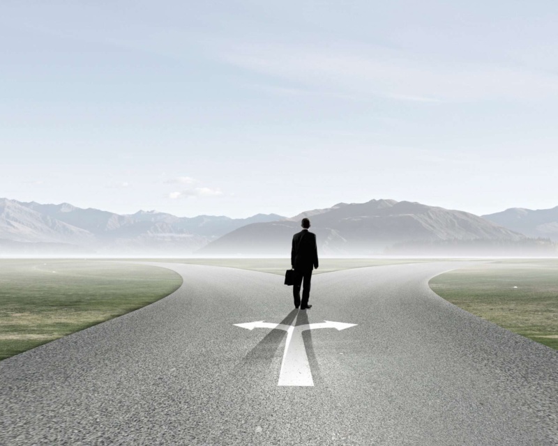 A man walking on a street with arrows representing two different paths to take