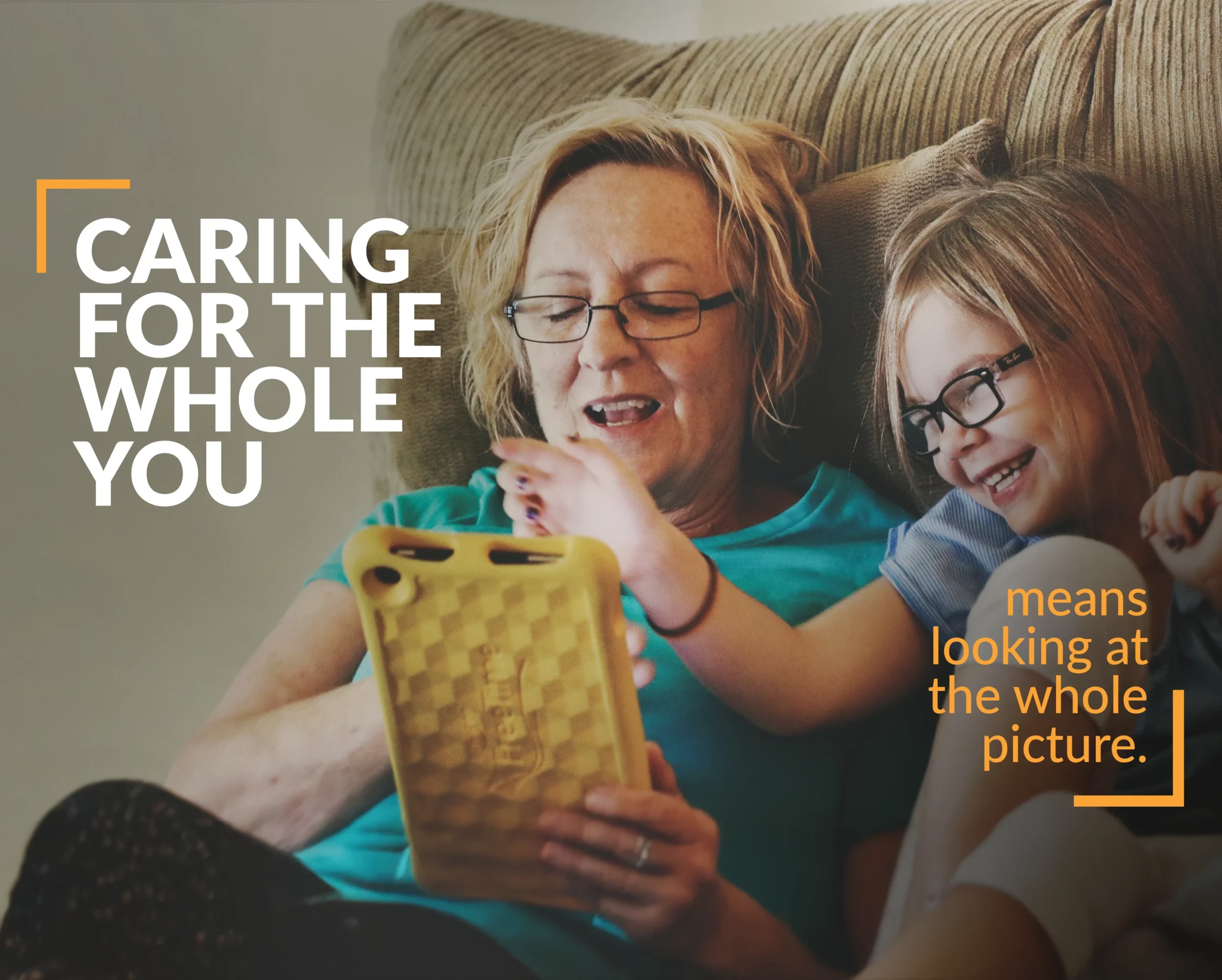 A mother and young daughter playing on a mobile device. With text "caring for you means looking at the whole picture"
