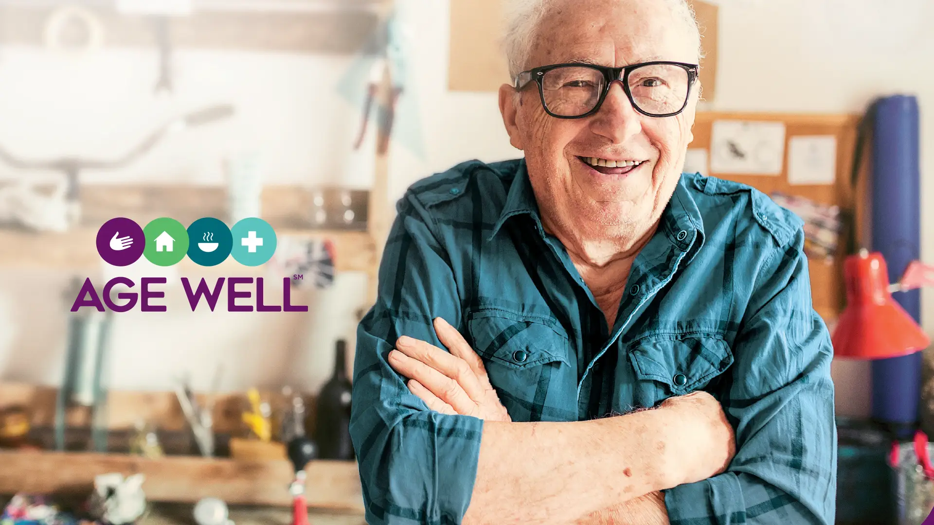 An older man looking happy in his workshop. Age well logo is on the left side of the image