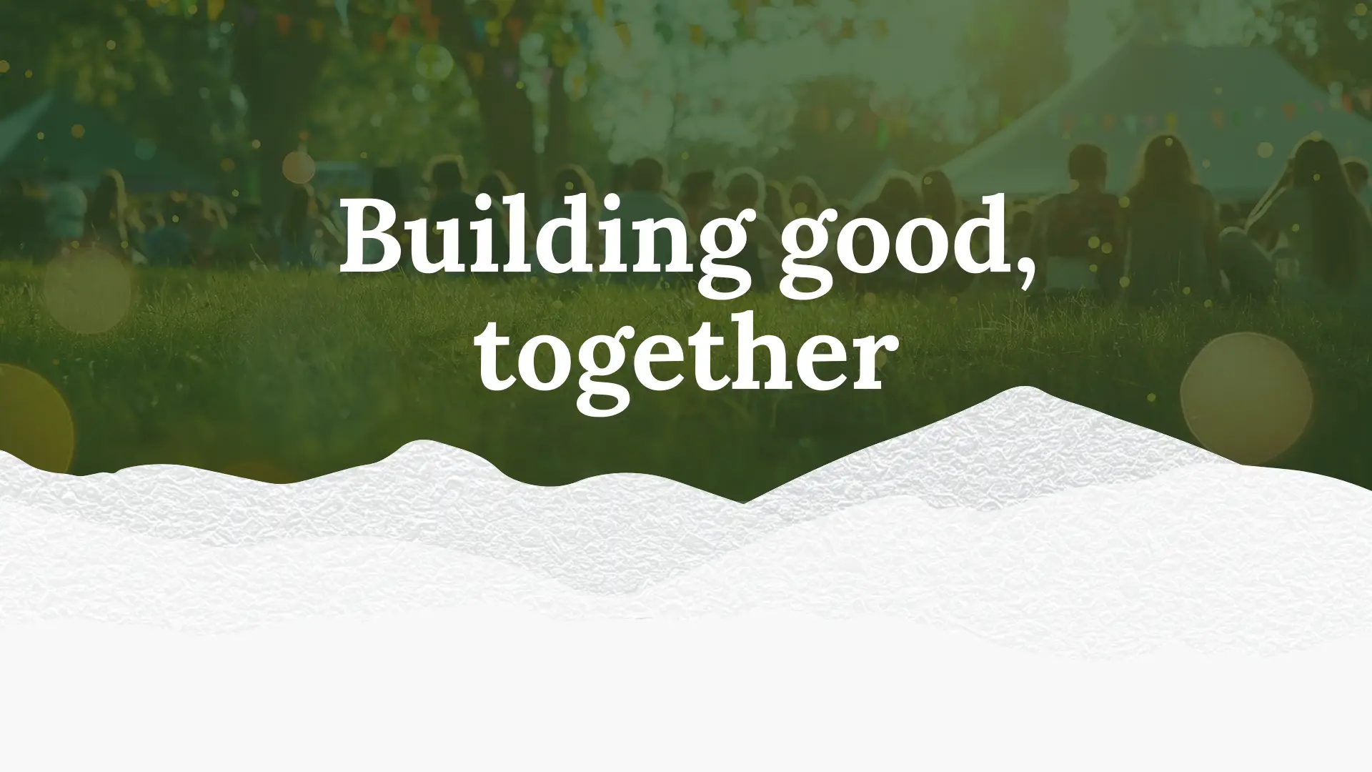 Image of white mountains with a green backdrop that says "building good, together". Behind the green is a faint photo of children sitting in grass